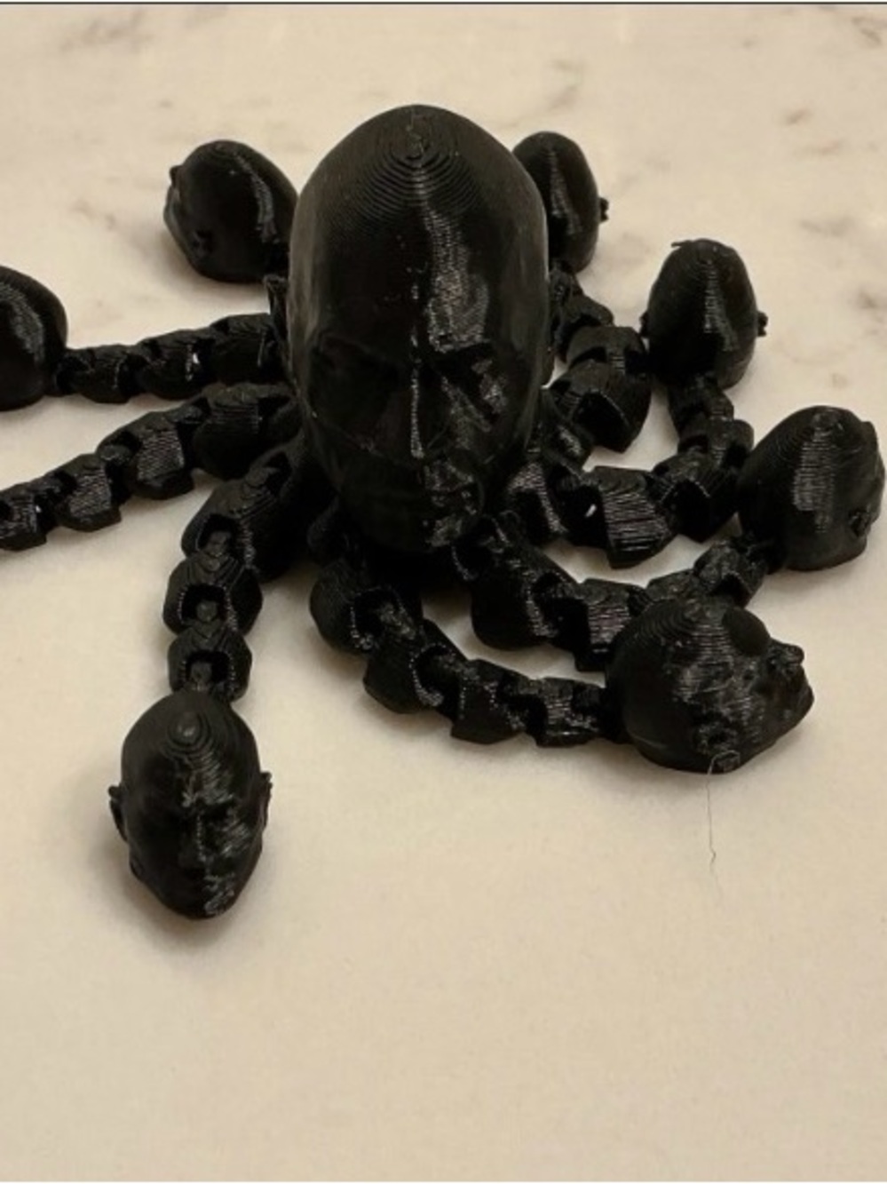 Black 3D Printed Octopus Sculpture with Human-Head Details